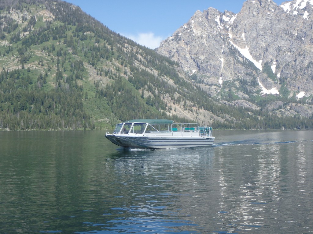 Boats go across Jenny Lake frequently during the day