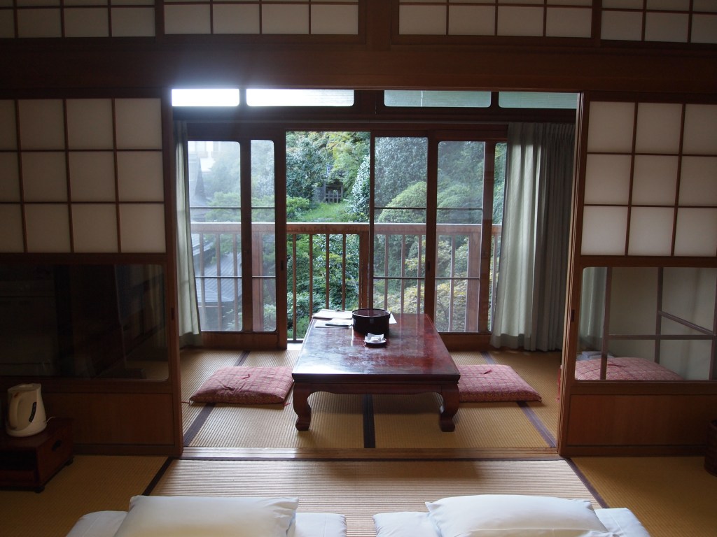 A nice little sitting area with screen doors and a view 