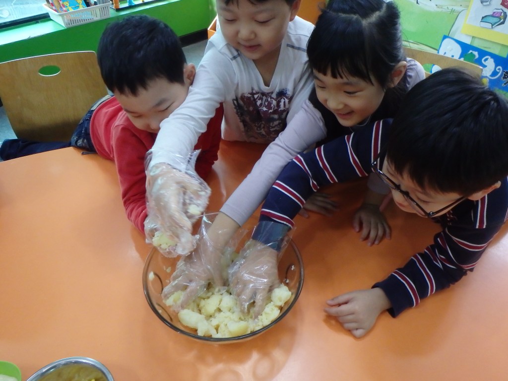 Mashing the potatoes and mixing in the corn and mayo