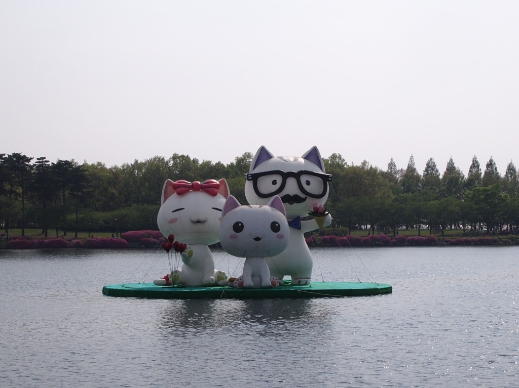Giant inflated cats in the lake