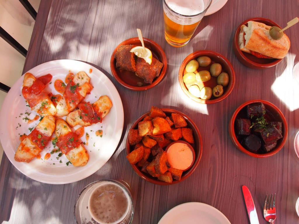 Our pintxos feast - marinated green olives, patatas bravas, paella roll, jamon & manchego toast, chorizo pamplona & manchego sandwich, and Basque meatballs